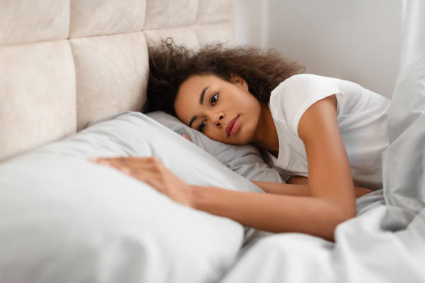 istock Frustrated Black Lady Touching Empty Pillow Lying In Bed Indoors 2167143678