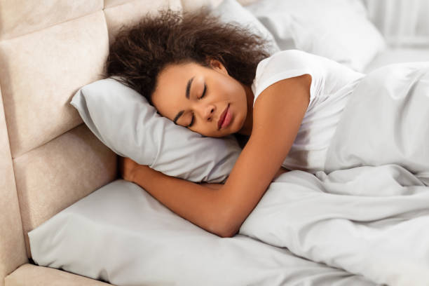 istock African American Lady Sleeping Peacefully Embracing Pillow In Modern Bedroom 2167143745