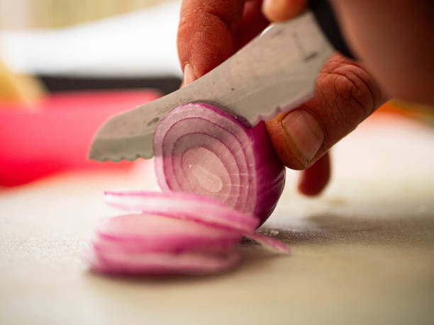 istock Cutting onion slices in preparation for a bbq 2167145090