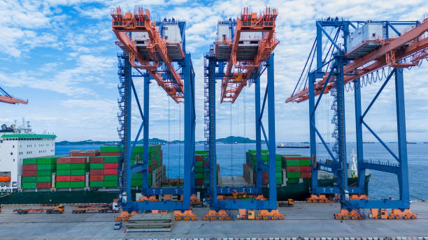 istock crane loading cargo container from truck to container ship in the international terminal logistic sea port concept freight shipping by ship. industry transportaion 2167145784
