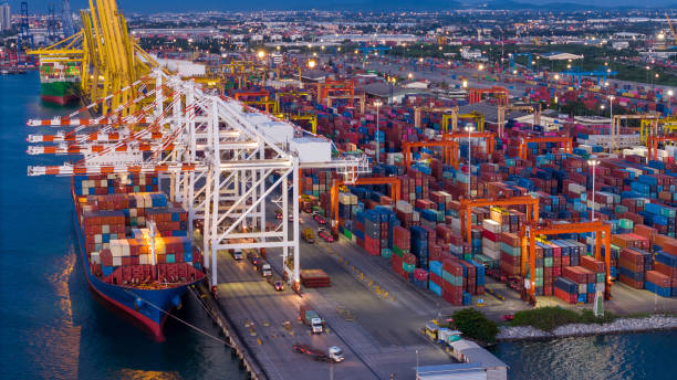 istock crane loading cargo container from truck to container ship in the international terminal logistic sea port concept freight shipping by ship. industry transportaion 2167145857