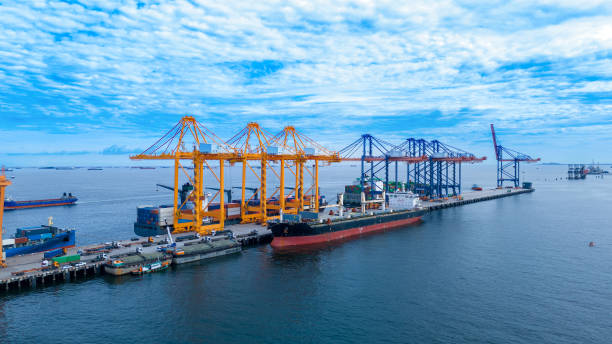 istock crane loading cargo container from truck to container ship in the international terminal logistic sea port concept freight shipping by ship. industry transportaion 2167145956