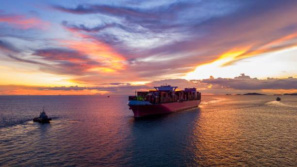 istock Cargo Container Ship at sunset in the ocean ship carrying container and running for export concept technology freight shipping by ship 2167145995
