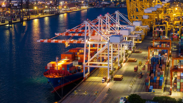 istock crane loading cargo container from truck to container ship in the international terminal logistic sea port concept freight shipping by ship. industry transportaion 2167146303