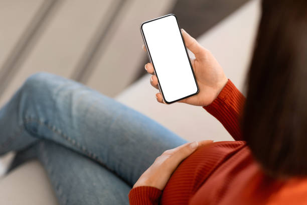 istock Unrecognizable Pregnant Woman Using Smartphone With Blank Screen At Home 2167146334