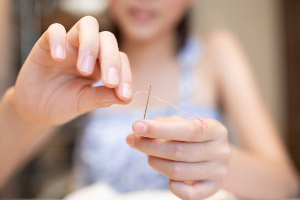 istock The hands of a child embroidering 2167152081