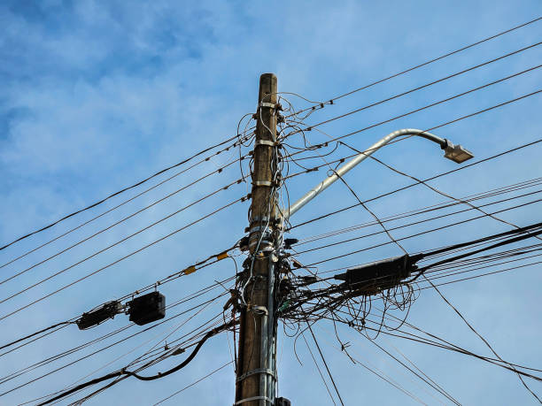 istock Street light with electricity utility pole and electrical wires, low angle view 2167153615