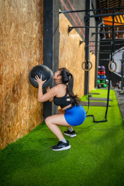 istock Woman working out in a gym using medicine ball 2167154205