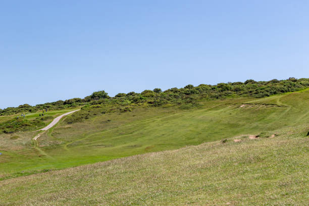 istock Rolling green hills with a clear blue sky on a sunny day, ideal for backgrounds or nature themes at Seven Sisters, England. 2167159659