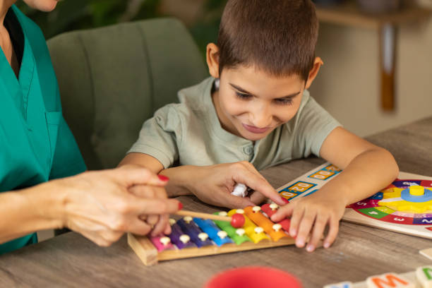 istock Nurse Engaging Boy with Autism in Sensory Play 2167161053