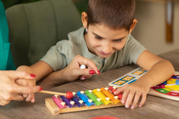 istock Nurse Engaging Boy with Autism in Sensory Play 2167161201