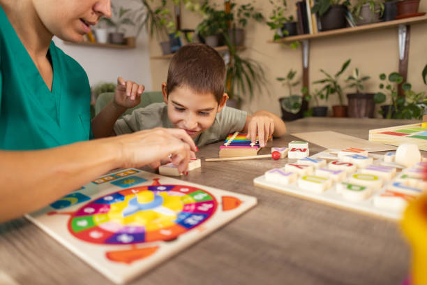 istock Nurse Helps Child with Autism Learn Alphabet 2167161456