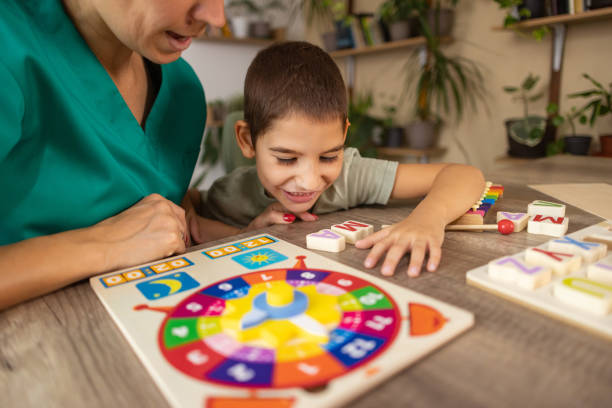 istock Nurse Helps Child with Autism Learn Alphabet 2167161474