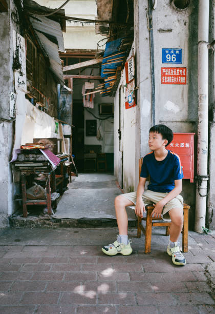 The boy sitting in the alley