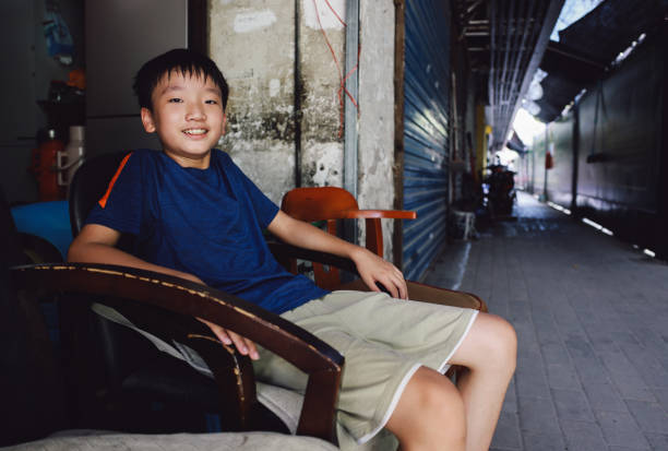 The boy sitting in the alley