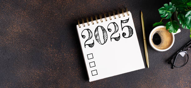 istock New year resolutions 2025 on desk. 2025 goals list with notebook, coffee cup, plant on table. Resolutions, plan, goals, action, checklist, idea concept. New Year 2025 resolutions 2167166630
