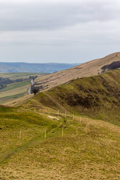 istock Rolling hills with a fence line, under a cloudy sky. Ideal for depicting tranquil rural landscapes in Peak District, England. 2167168540