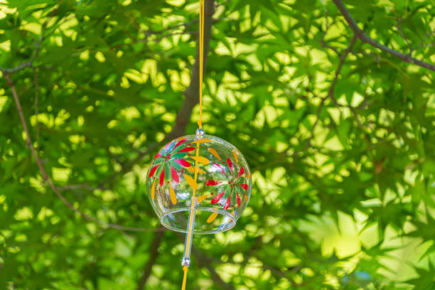 istock Vibrant Summer Wind Chime Hanging in Green Foliage 2167169211
