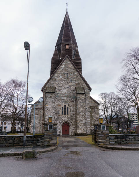 Vangskyrkja, a medieval stone church in Voss, Norway, showcases stunning architecture and rich Scandinavian heritage amid picturesque landscapes.