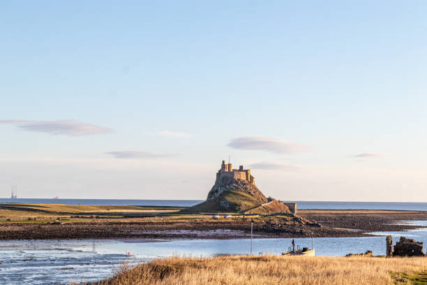 istock Serene coastal landscape with historic castle on a hill under a clear blue sky. 2167169534