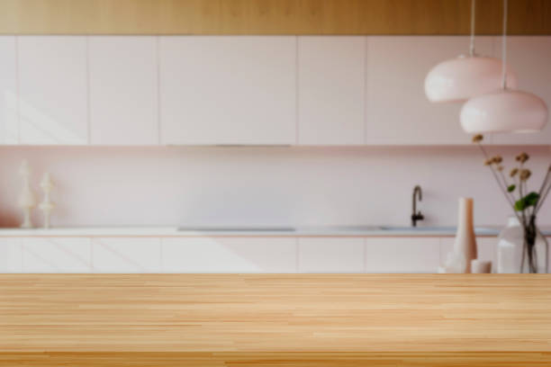Interior of a kitchen with lots of wood in an old Italian style. In the foreground is the table and chairs. No one inside.
