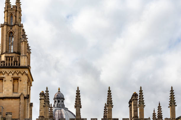 Historic architecture with spires against a cloudy sky in Oxford, England.