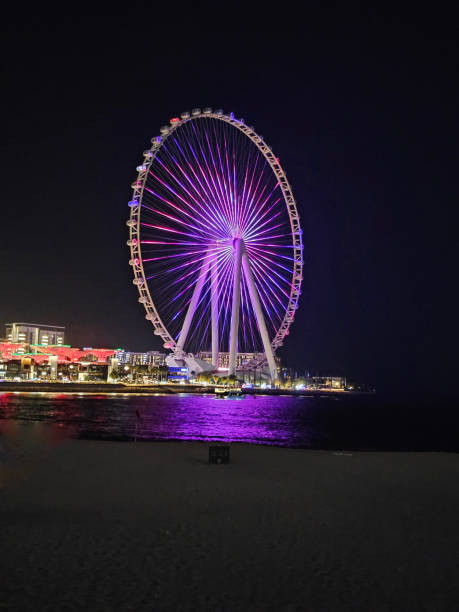 istock Colorful illuminated Ferris wheel at night beside the coast 2167174640