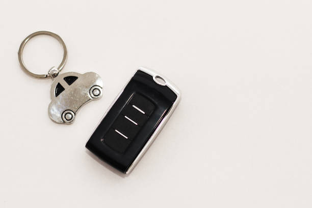 car keys, remote control on a wooden background