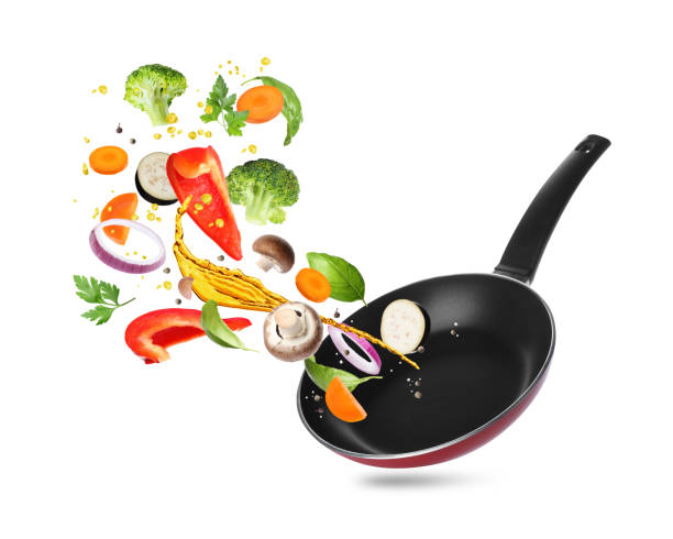 istock Different vegetables, oil, frying pan in air on white background 2167182609