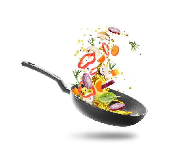 istock Different vegetables, oil, frying pan in air on white background 2167182617