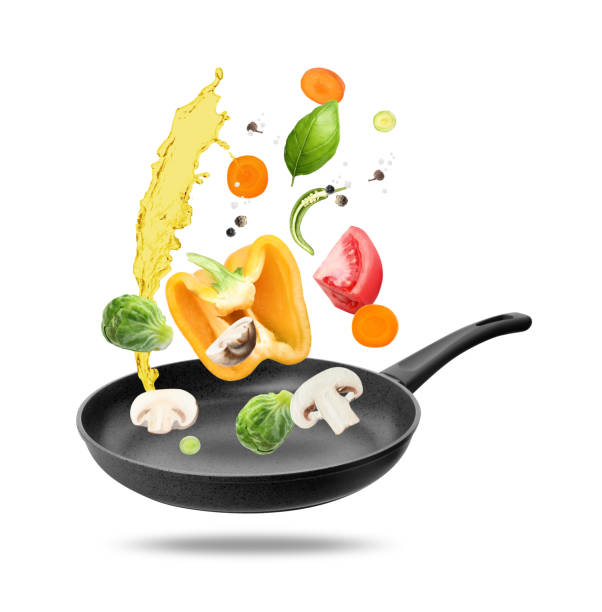istock Different vegetables, oil, frying pan in air on white background 2167182625