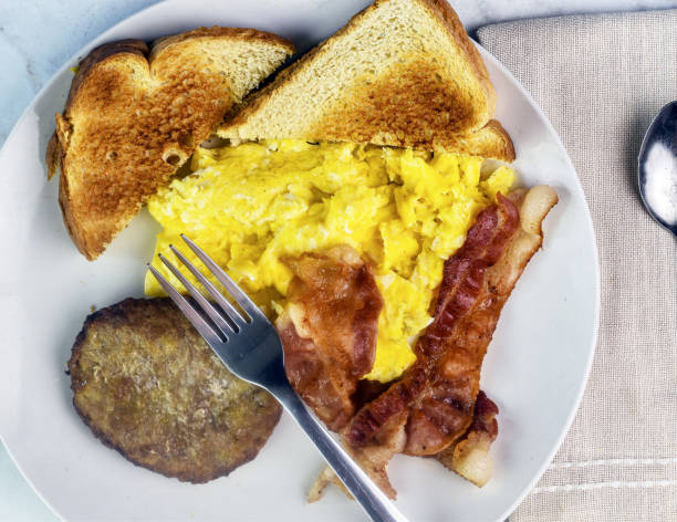istock scramble eggs  with bacon and sausage patty 2167183930