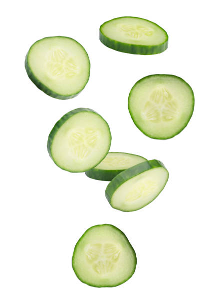 istock Sliced cucumbers form an abstract figure in space. Isolated on white 2167187259