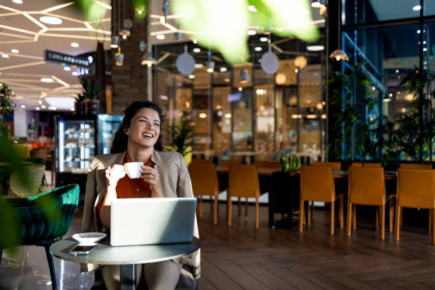 istock Woman joyfully holding coffee cup in a well-lit cafe 2167188810