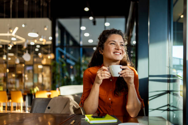 Person enjoying coffee in a modern cafe setting.