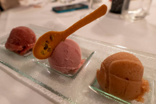 Berry sorbet with three flavors - strawberry, raspberry, black currant. Scoop ice cream sorbet decorated fresh berries and mint. Summer ice cream concept