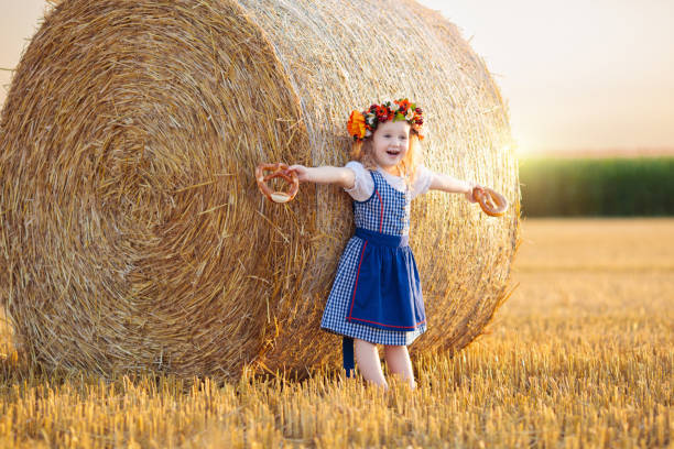 istock Child in wheat field with German bread 2167200074