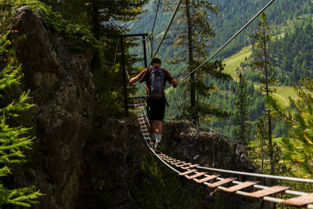 istock Climber on via ferrata in the larix wood 2167201687