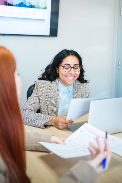 istock Young women working together on a collaborative business project in a bright co-working space 2167202453