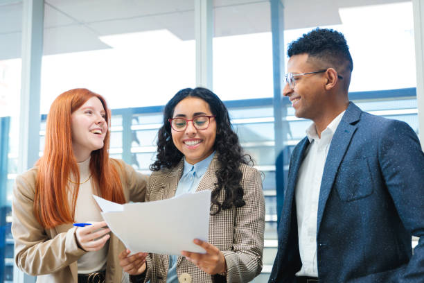 istock Young adults working together on a collaborative business project in a co-working space 2167202461