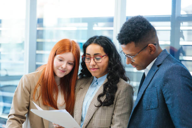 istock Young adults immersed in a collaborative business project in a bright co-working space. 2167202498