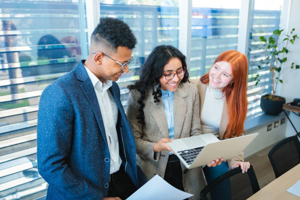 istock Smiling young businesspeople teamwork engaged in a collaborative discussion in an office 2167202601