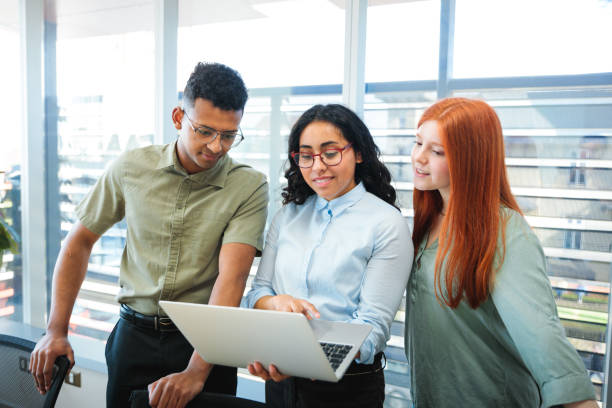 istock Young Cheerful Teamwork Business People Collaborating and Using Laptop in Conference Room Office 2167202872