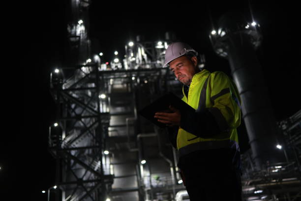 istock At a power plant, a senior engineer wearing a safety uniform is using a digital tablet during the night shift. This power plant might be involved in producing electricity from coal, oil or natural gas, or producing other products like gasoline or plastics 2167204014