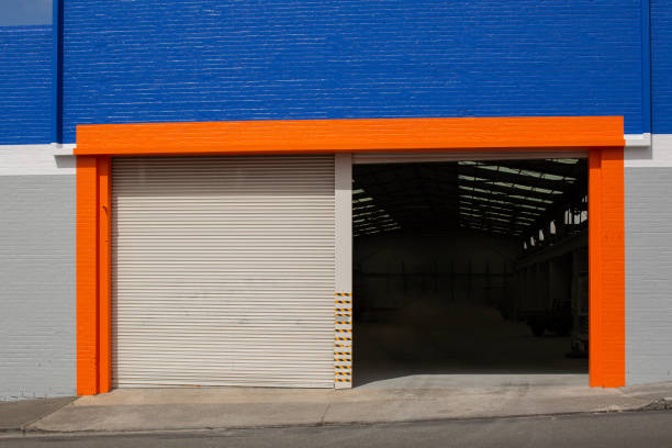 istock Workshop building with one roller door open and the other closed 2167212175