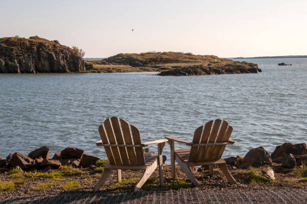 istock Deck chairs by water on a summer evening 2167214291