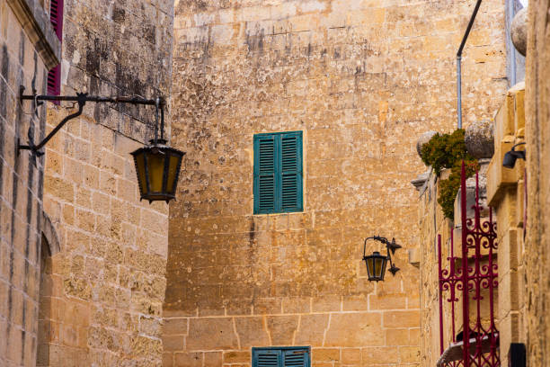 Malta, Mdina. Shuttered windows in a stone wall.