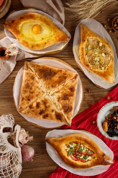 istock Assorted Georgian Pastries Khachapuri and Penovani Arrangement on Rustic Table 2167219717