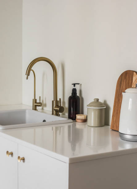 istock Minimalistic style kitchen interior. Electric kettle, cutting board, dispenser, brush near the sink, on the stone countertop 2167220179