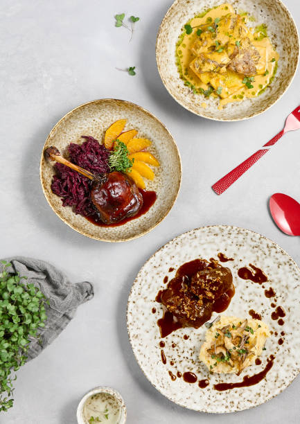 istock Delicious Hot Entrees Plated on Concrete Tabletop with Artistic Presentation and Garnishes 2167220676